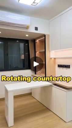 an empty kitchen with white counter tops and cabinets in front of a large window that reads rotating countertop