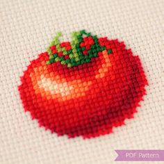 a close up of a cross stitch pattern of a tomato