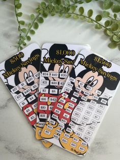 three mickey mouse stickers sitting on top of a table