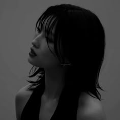 a black and white photo of a woman with long hair wearing a halter top