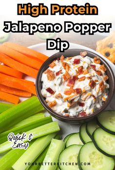 a bowl of dip surrounded by sliced cucumbers and carrots with the words high protein jalapeno popper dip