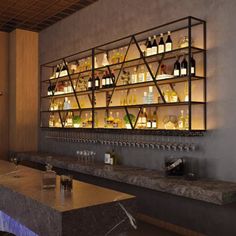 an empty bar with bottles and glasses on it