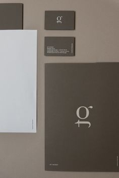 the letter q is placed next to two business cards