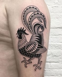 a black and white rooster tattoo on the left arm