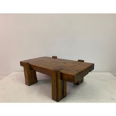 a wooden table sitting on top of a white floor