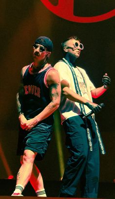 two men standing next to each other on stage