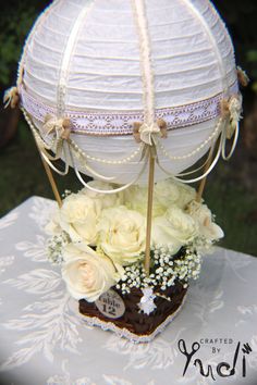 a cake with flowers on it sitting on top of a white tablecloth covered table