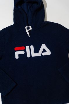 "This is a vintage fleece hoodie by Fila. The sweater is a very soft navy blue material. The drawstrings of the hood are braided white strings. The front of the fleece showcases a large FILA in red and white. Tina the Mannequin loves how comfy this fleece is! She wants to wear it out and then wear it to bed.  Tina love the navy blue color too. Tina thinks you will love this fleece so much! Or maybe it's the perfect gift for your loved on! Tina will have it wrapped up for you right away! Tag: Fila Size: M Measurements; Chest: 20.5\" Sleeve: 24\" Length: 23.5\" Materials: Cotton, Polyester Stored in a smoke-free, pet-free environment. Please note that not all screens are properly color calibrated. All images are taken with professional photo gear and edited using professionally calibrated sc Blue Hoodie With Drawstring For Winter, Fleece Sweatshirt With Drawstring, Blue Drawstring Hoodie For Winter, Navy Hoodie For Winter Loungewear, Navy Hooded Hoodie For Loungewear, Navy Winter Hoodie For Loungewear, Navy Hoodie With Drawstring For Loungewear, Navy Drawstring Hood Loungewear Hoodie, Cozy Fleece Sweatshirt With Drawstring