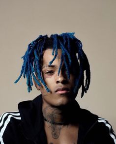 a man with blue dreadlocks on his head