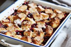 a casserole dish with blueberries and bread crumbs