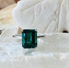 This classic 4 prong setting contains a beautiful 4.00ct. lab created emerald cut emerald. The emerald cut stone measures approximately 10x8mm. The ring is available in sterling silver, and 14k white, yellow, or rose gold. This ring makes a great promise or engagement ring. Emerald is the birthstone for May. Please send me a message if you need a size not listed. * This ring can be customized with any color center stone. All items are handmade by me in my shop in Woodbridge, NJ. Please message m Emerald Ring White Gold, Emerald Solitaire Ring, Engagement Ring Emerald Cut, Gold Emerald Ring, Emerald Cut Engagement Ring, Silver Emerald Ring, Engagement Ring Emerald, Plain Gold Ring, May Birthstone Rings