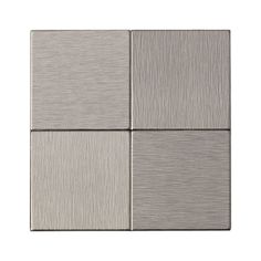 four square metal tiles on a white background