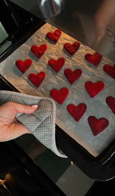 someone is drying hearts on a baking sheet