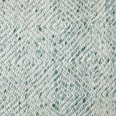 the texture of an upholstered rug with blue and white colors is shown in closeup