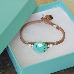 "Sterling Wire Wrapped Leather Cord Bracelet with Faceted Turquoise - Turquoise and Rhinestones - Turquoise Nugget Our single gemstone and leather bracelets are one of the most popular designs from our Della Terra Collection. This bracelet features a stunning, faceted turquoise nugget that is artfully wrapped with sterling silver wire to a length of coffee colored leather. The turquoise nugget is flanked by crystal rhinestone rondelles and lustrous, white Swarovski pearls, adding just the right Southwestern Turquoise Leather Bracelet As Gift, Southwestern Style Turquoise Leather Bracelet, Leather Cuff Bracelet Diy, Cuff Bracelets Diy, Diy Leather Bracelet, Customised Bracelets, Beaded Leather Bracelet, Leather Cord Bracelets, Easy Jewelry