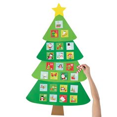 a person is holding up a christmas tree with pictures on the top and bottom of it