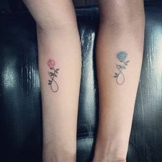 two women with matching tattoos on their arms and legs, both have roses tattooed on them