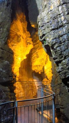 the stairs lead up to an entrance into a cave with yellow light coming from it