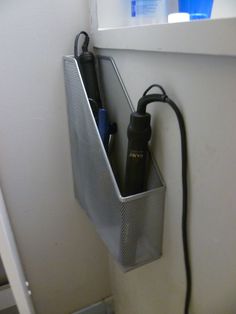 a cell phone is hooked up to an electrical outlet on the wall in front of a window