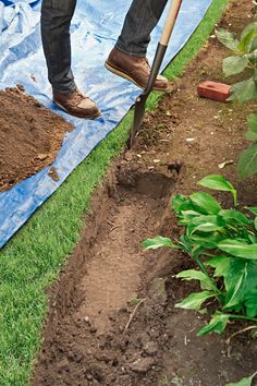 a man is digging in the ground with a shovel