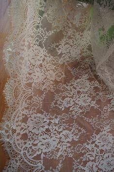 an old lace doily on a wooden floor