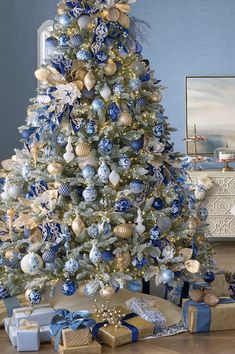 a decorated christmas tree with blue and gold ornaments