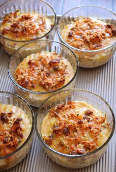 four glass bowls filled with food on top of a table