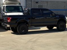 a black truck parked in front of a building