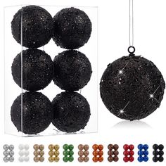 black glittered balls in a clear box with different colors