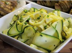 a white bowl filled with sliced up zucchini