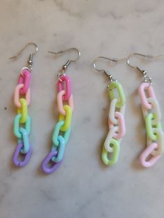 "Your choice of two kinds of chain earrings! These chain links are half an inch long and are a nice medium sort of size.  The rainbow pair measure 2.5\" long The green and pink pair measure 2\" long and are slightly mismatched for a fun look.  All of my earrings come with little silicone backs." Trendy Pink Chunky Chain Jewelry, Trendy Colorful Chain Jewelry, Trendy Pink Link Jewelry, Trendy Green Chain Link Jewelry, Pink Chunky Link Chain Jewelry, Pink Chunky Chain Link Jewelry, Trendy Rainbow Dangle Jewelry, Trendy Colorful Dangle Jewelry, Kawaii Ring