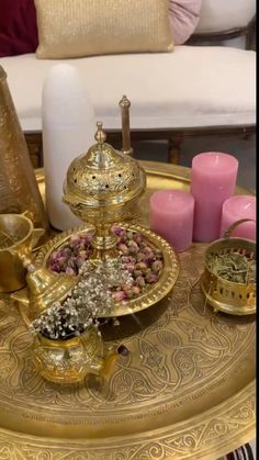 a gold tray topped with lots of different types of items on top of a table