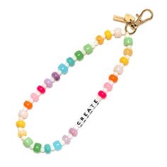 a colorful beaded necklace with the word create on it and a gold keychain