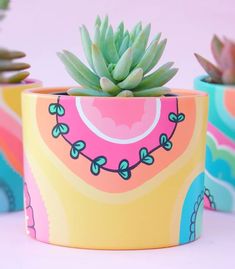 a potted plant sitting on top of a table next to other pots filled with plants