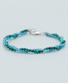 a blue beaded bracelet with silver clasp