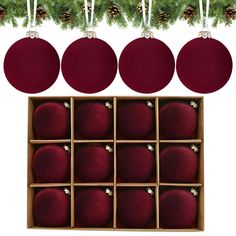 six red ornaments hanging from a christmas tree with pine cones on the top and below them