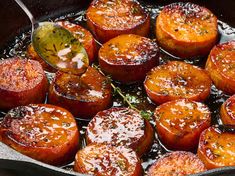 cooked carrots in a skillet with a spoon