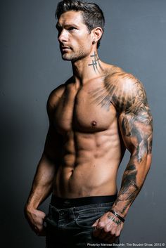 an image of a man with tattoos on his chest