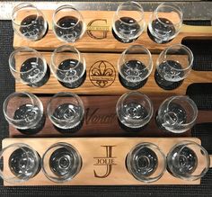 wine glasses are lined up on a wooden rack