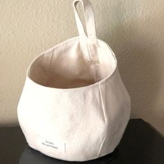 a white bag sitting on top of a black table