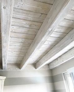 the ceiling in this room is made out of wood planks and painted with white paint