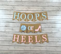 two pieces of cardboard with hooprs or heels cut out on them and hanging from the wall