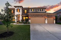 a two story brick home at sunset