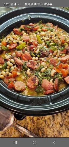 a crock pot filled with beans, ham and broccoli