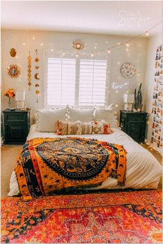 a large bed sitting in a bedroom on top of a colorful rug next to a window