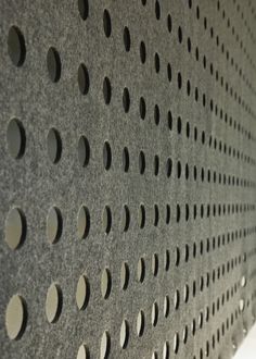 a close up view of a wall with holes in it