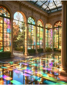 an image of a room with many windows and reflections in the water on the floor