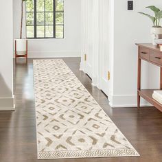 a white and beige rug in the middle of a room