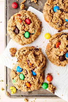 three cookies with m & m's on top and one chocolate chip cookie in the middle