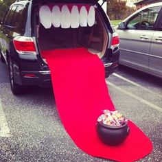 an open trunk with teeth on it and a red carpet